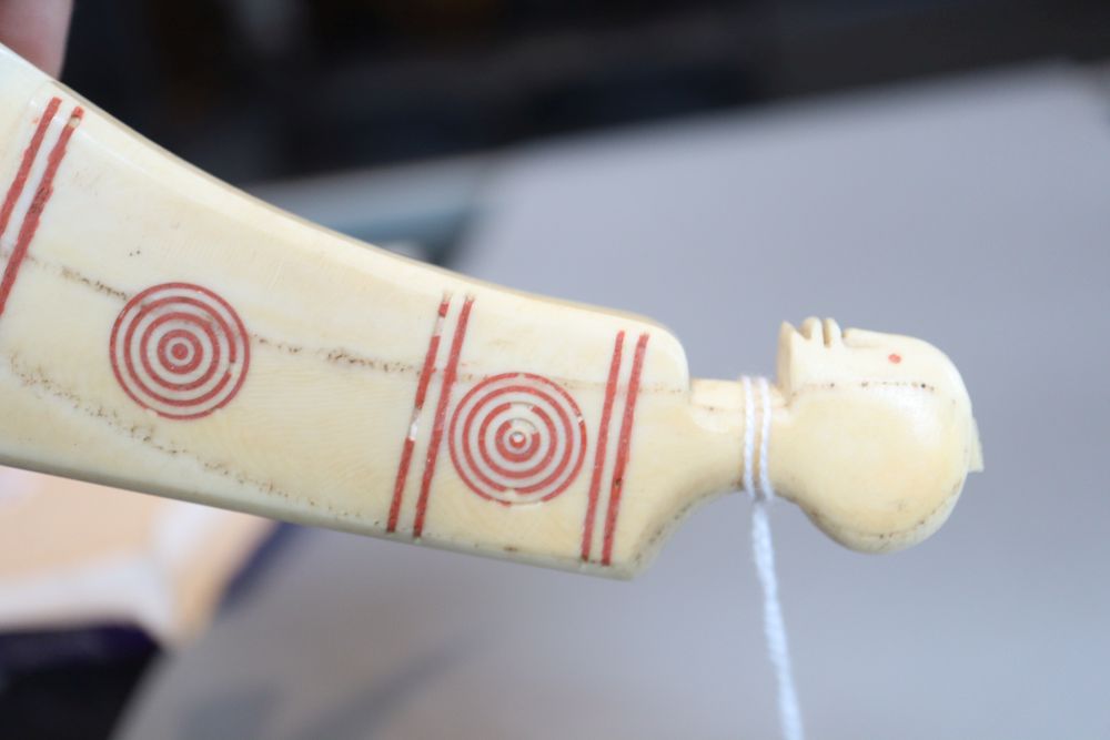 Two tribal carved warthog or boars tusk daggers, first half 20th century, picked out in red pigment